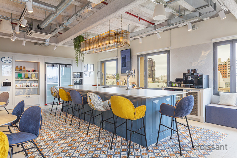 a room with a couch and a chair in front of a building