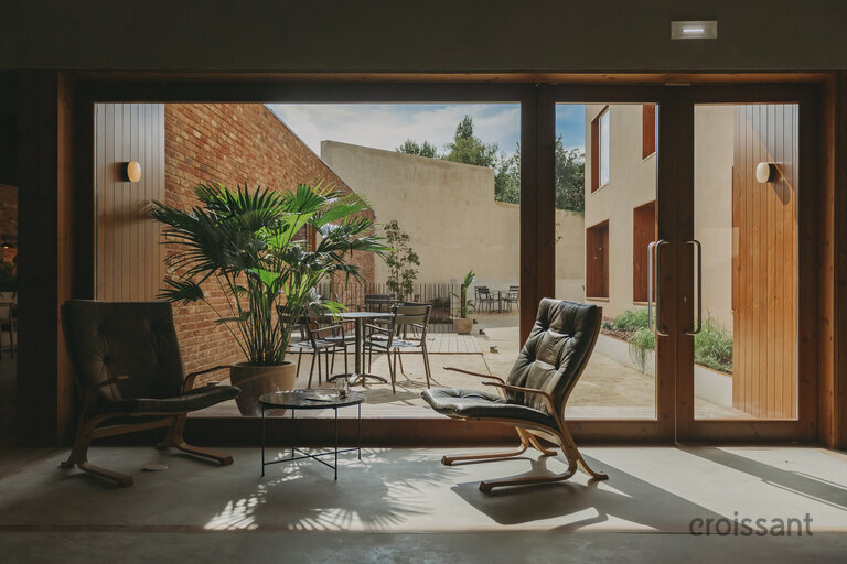 a living room filled with furniture and a large window