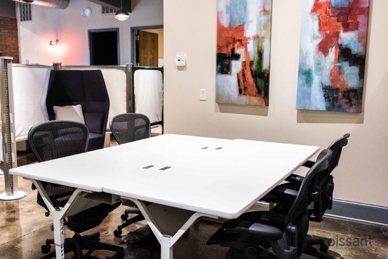 an office with a desk and chair in a room