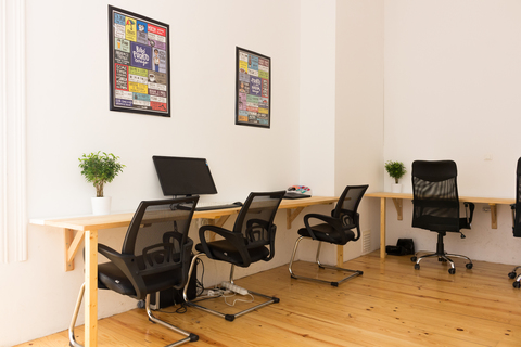 a living room with a desk and chair
