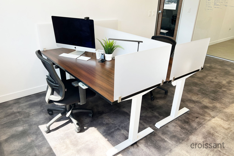 a desk with a laptop in a room