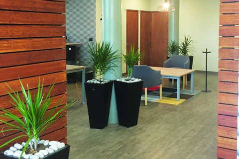 a room filled with furniture and vase of flowers on a table