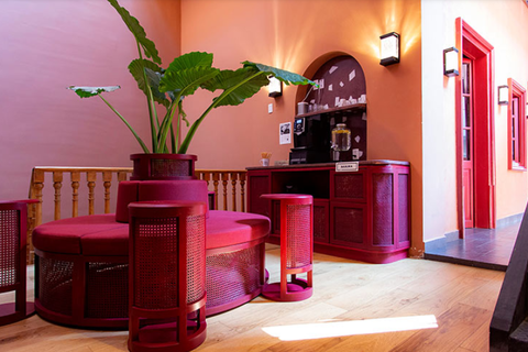 a room filled with furniture and vase of flowers on a table