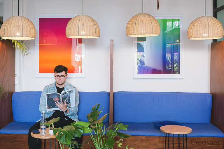 a person in a blue shirt sitting on a table