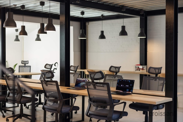 an office with a desk and chair in a room