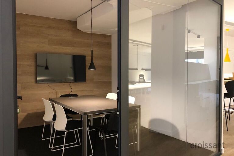 an office with a desk and chair in a room