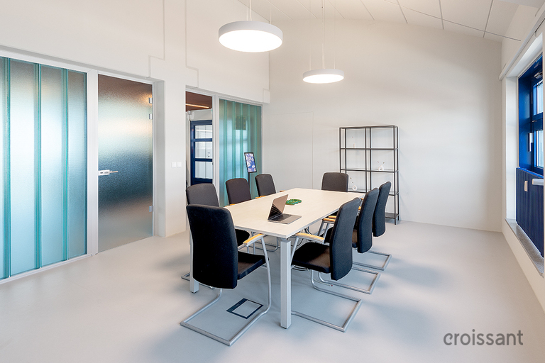 a room filled with furniture and a large window