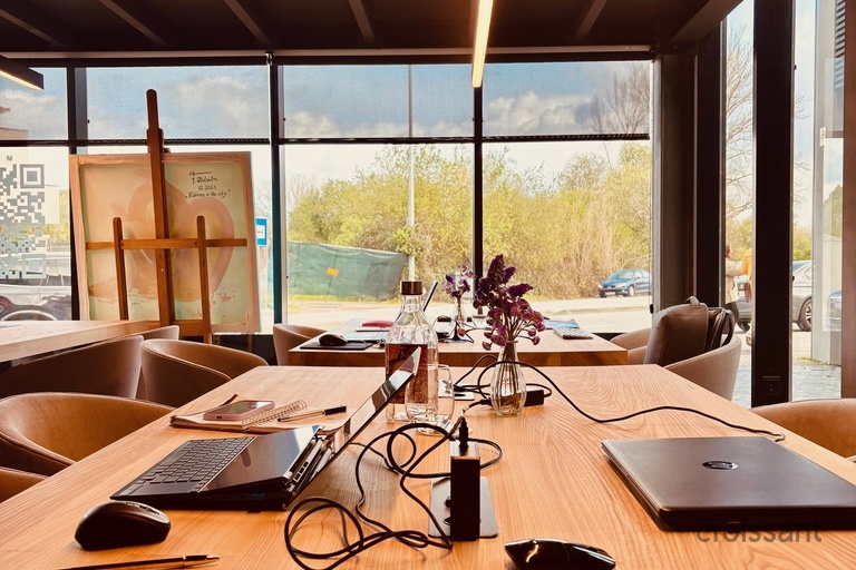 a laptop computer sitting on top of a wooden table