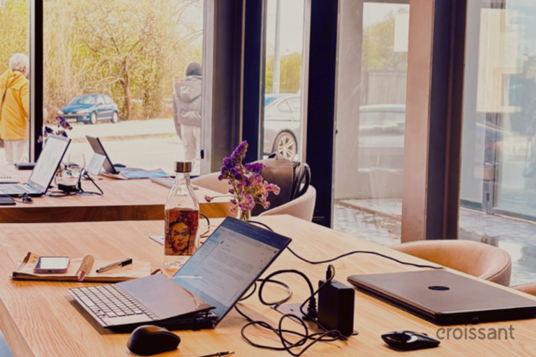 a desk with a laptop computer sitting on top of a wooden table