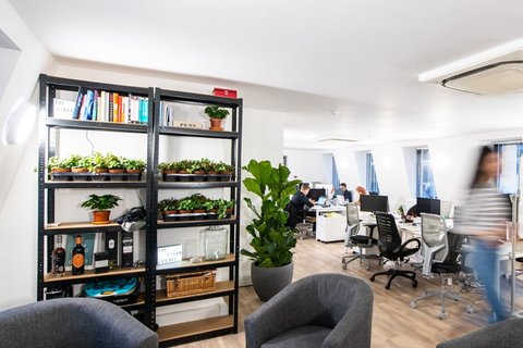 a living room filled with furniture and a large window