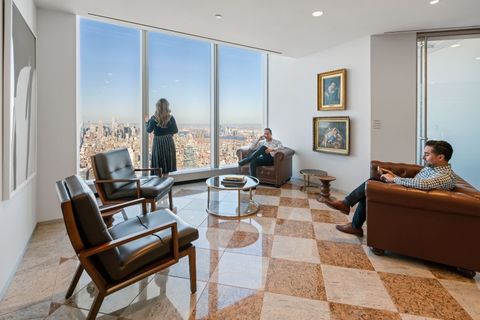 a living room filled with furniture and a large window