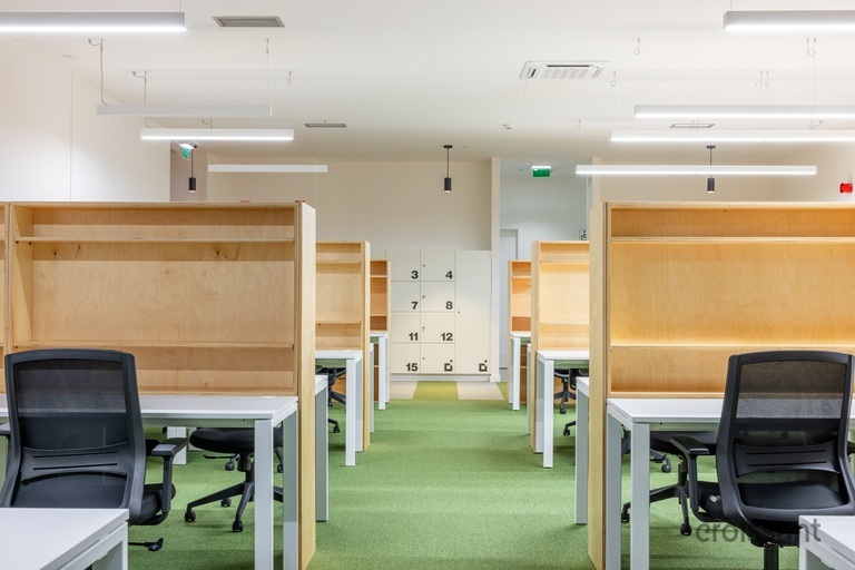 a desk with a computer and a chair in a room