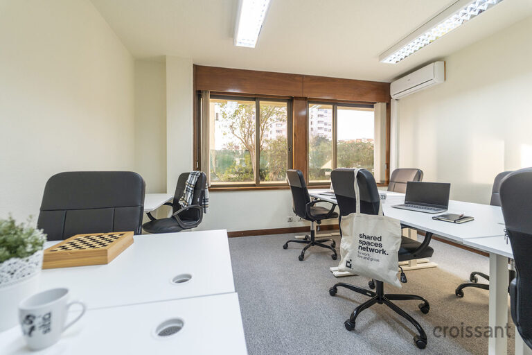 a room filled with furniture and a large window