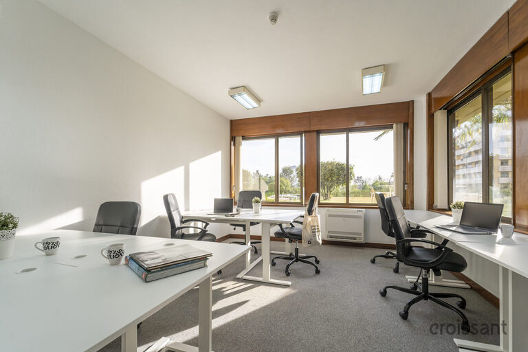 an office with a desk and chair in a room
