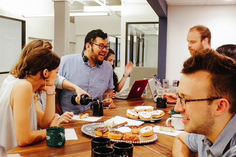 a group of people sitting at a table eating food