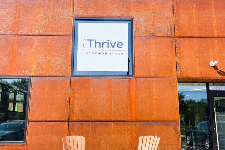a bench in front of a brick building