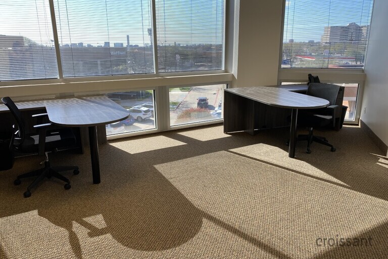 a living room filled with furniture and a large window