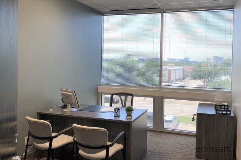 a room filled with furniture and a large window