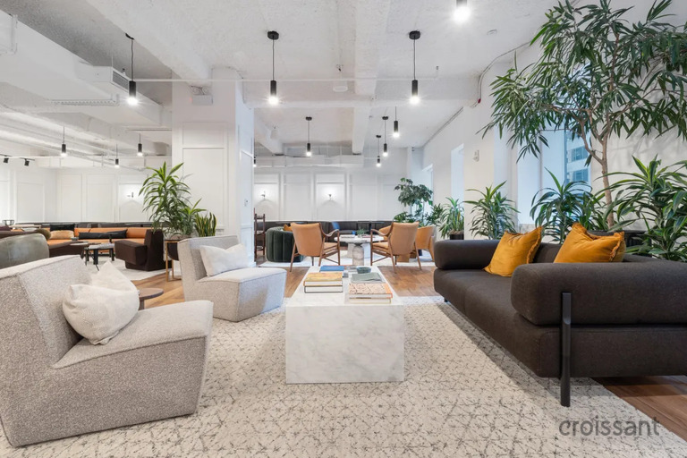 a living room filled with furniture and a large window