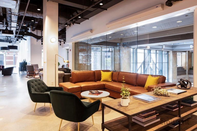 a living room filled with furniture and a large window