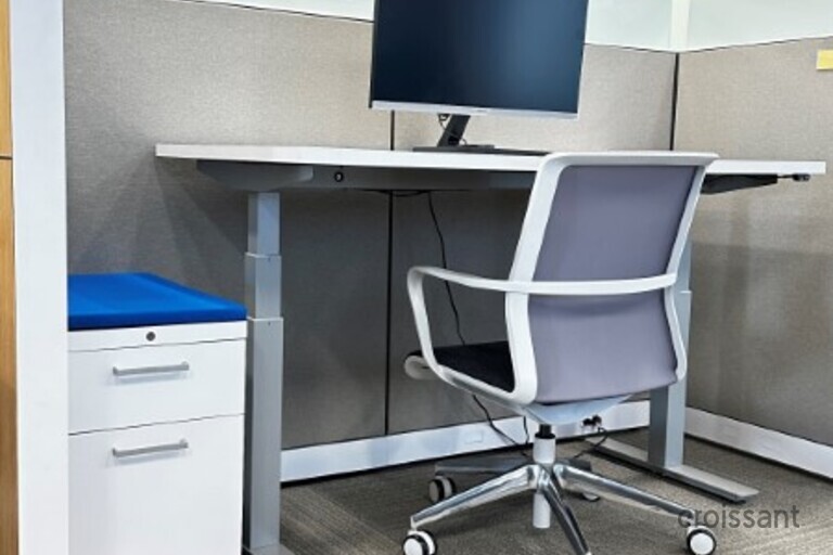 an office with a desk and chair in a room