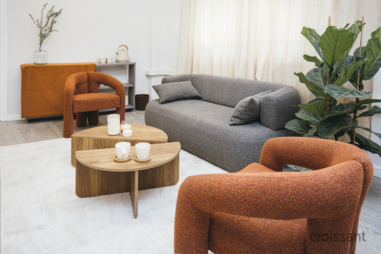 a living room filled with furniture and vase of flowers on a table