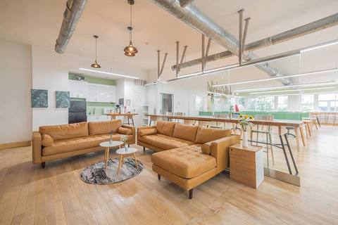 a living room filled with furniture and a wood floor