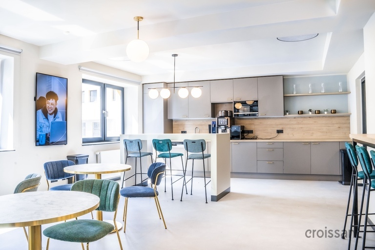 a kitchen with a blue chair