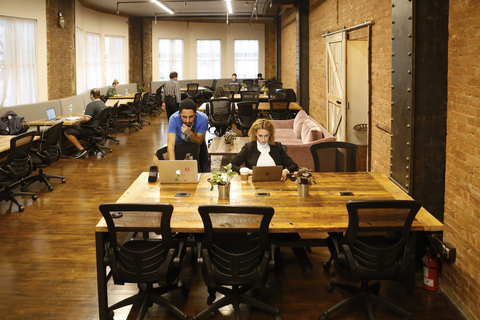 a group of people sitting at a table in a restaurant