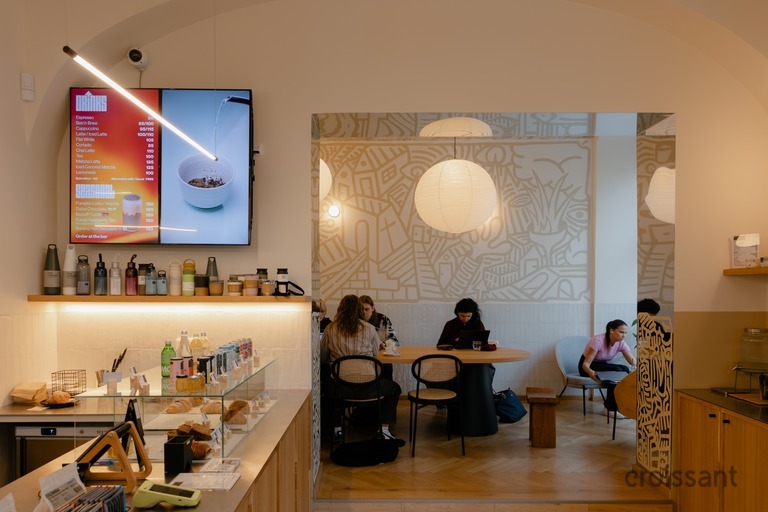 a person sitting at a table in front of a mirror