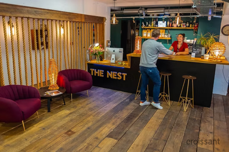 a person sitting in a living room with a wooden floor