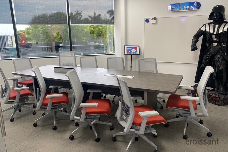 a person sitting at a desk in front of a window