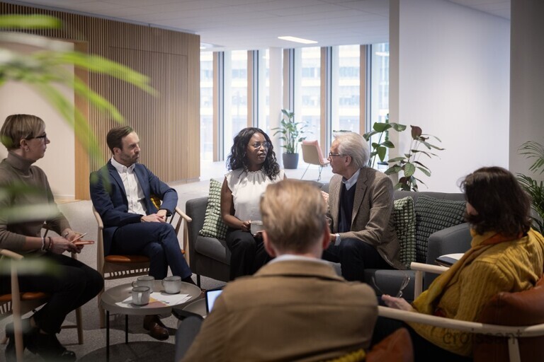 a group of people sitting at a table in a room