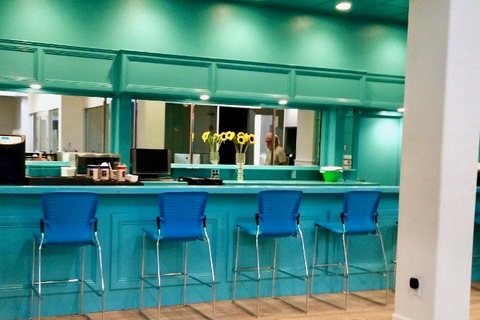 a kitchen with a blue chair