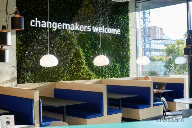 a group of people sitting at tables in a restaurant