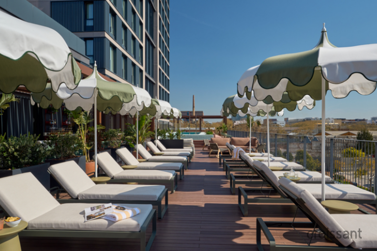 a deck with lounge chairs and umbrellas