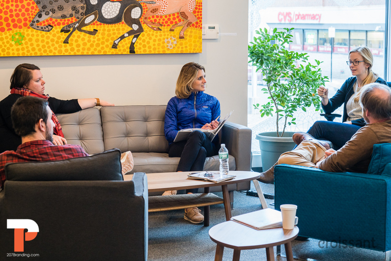 a group of people sitting around a living room