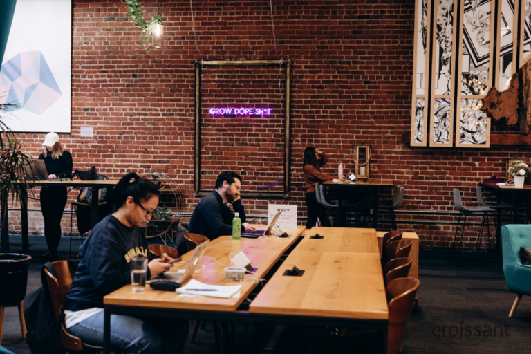 a group of people sitting at a table in a restaurant