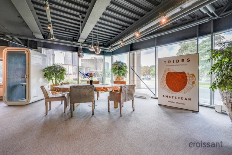 a room filled with furniture next to a building