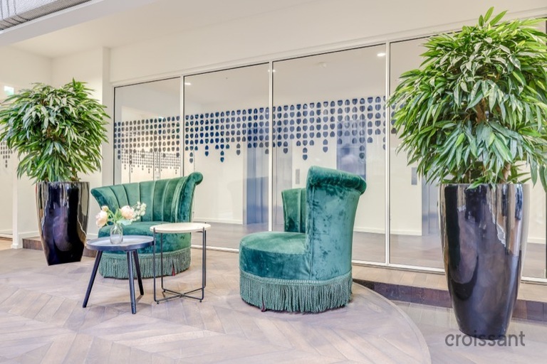 a room filled with furniture and vase of flowers on a table