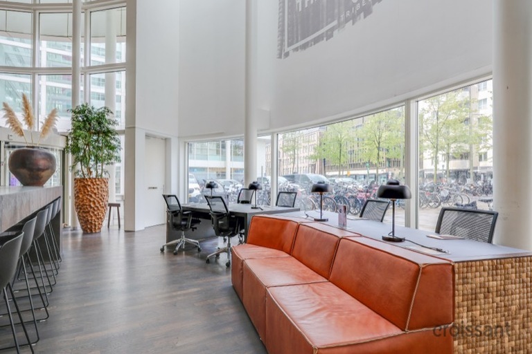 a living room filled with furniture and a large window