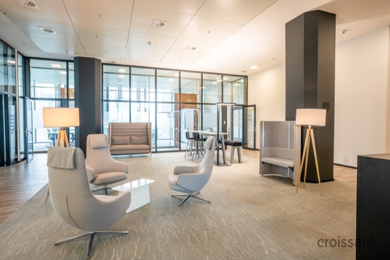 a living room filled with furniture and a large window