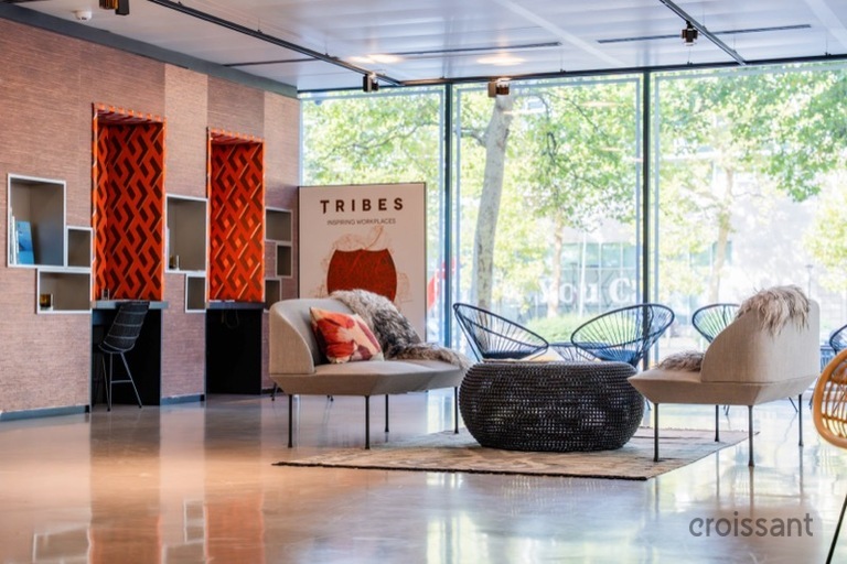 a living room filled with furniture and a large window