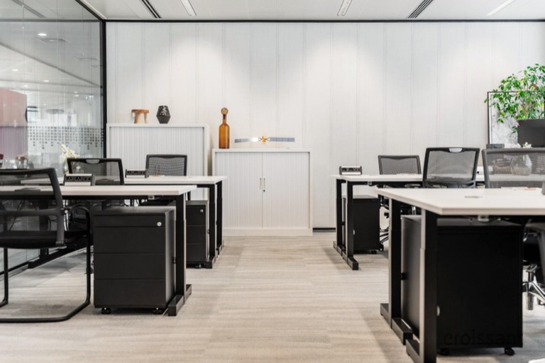 an office with a desk and chair in a room