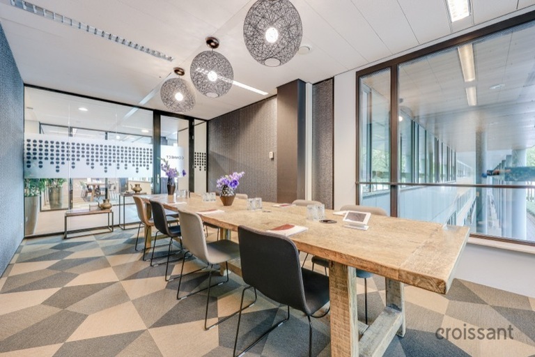 a kitchen with a table and chairs in a room