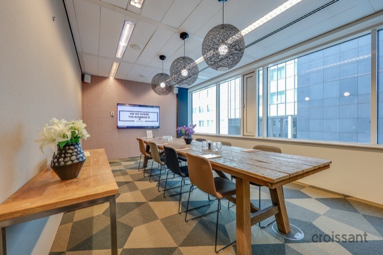 a wooden table next to a window