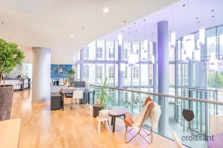 a living room filled with furniture and a large window