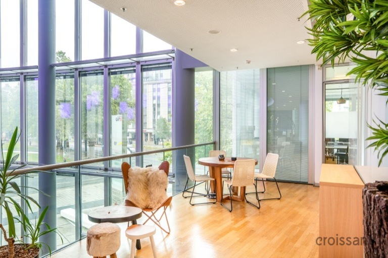 a living room filled with furniture and a large window