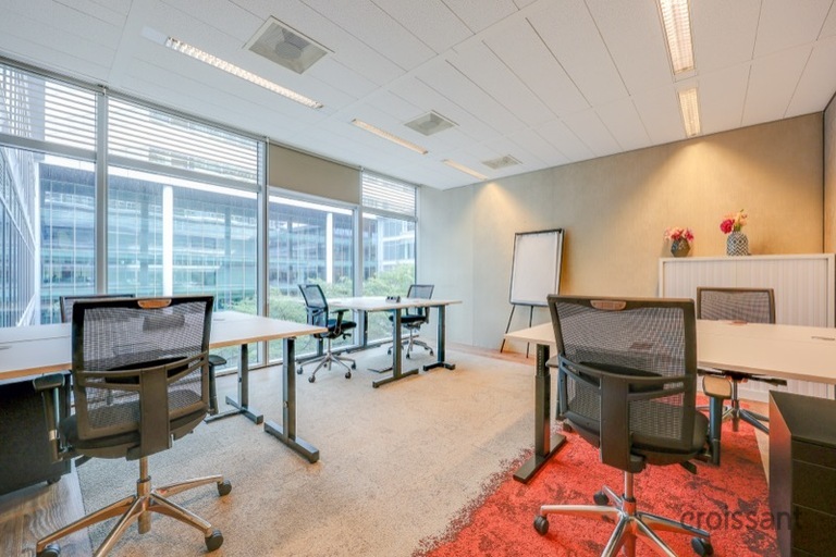 a living room filled with furniture and a large window