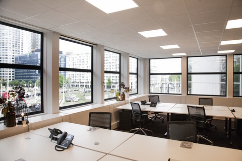 a room filled with furniture and a large window